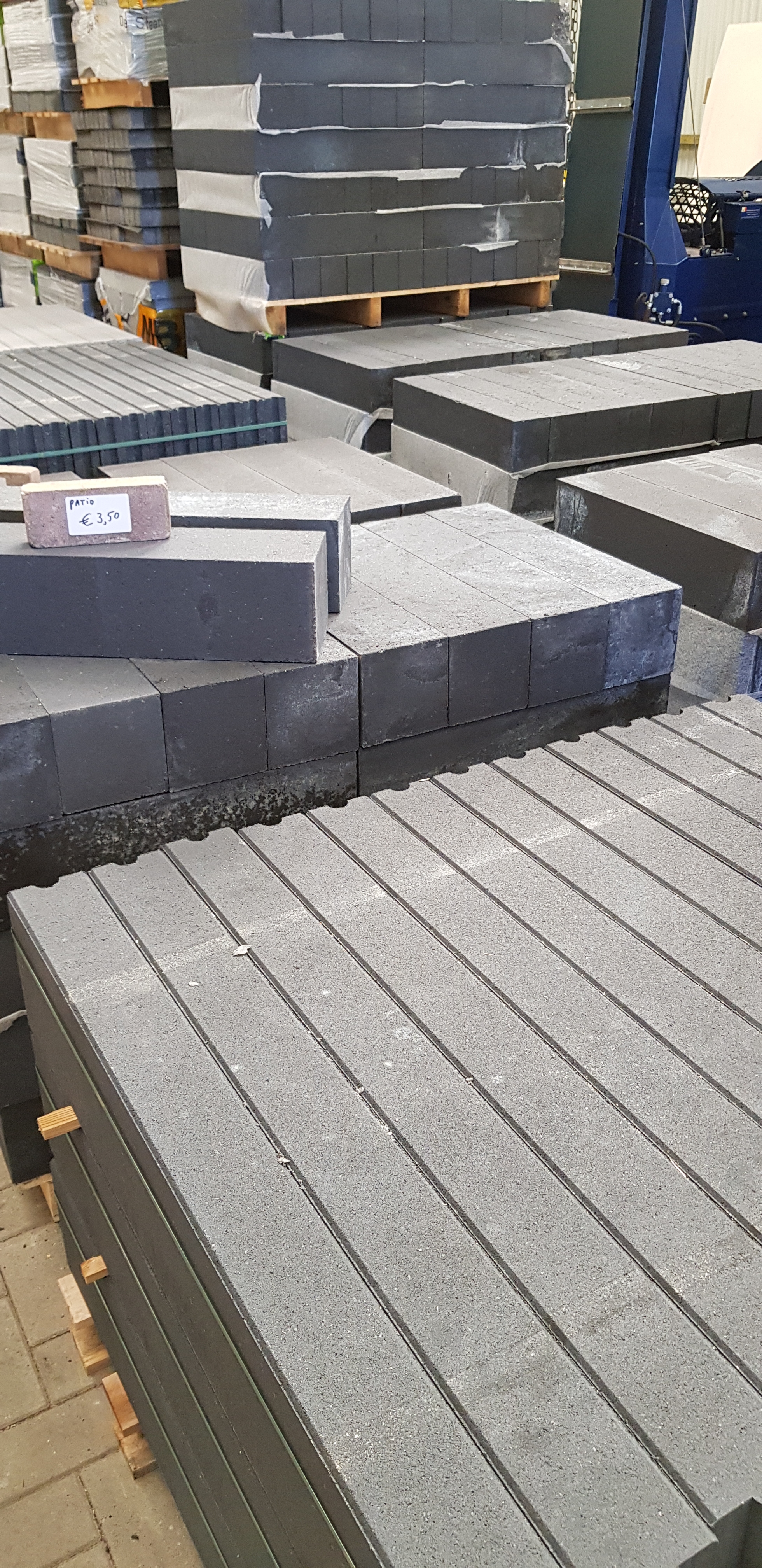 Antraciet stapelblokken en opsluitbanden op pallets, van dichtbij